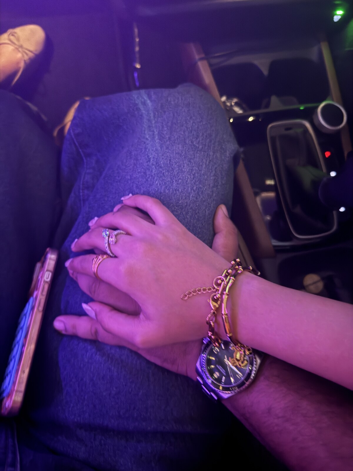 Rahul and Nancy holding hands in the car
